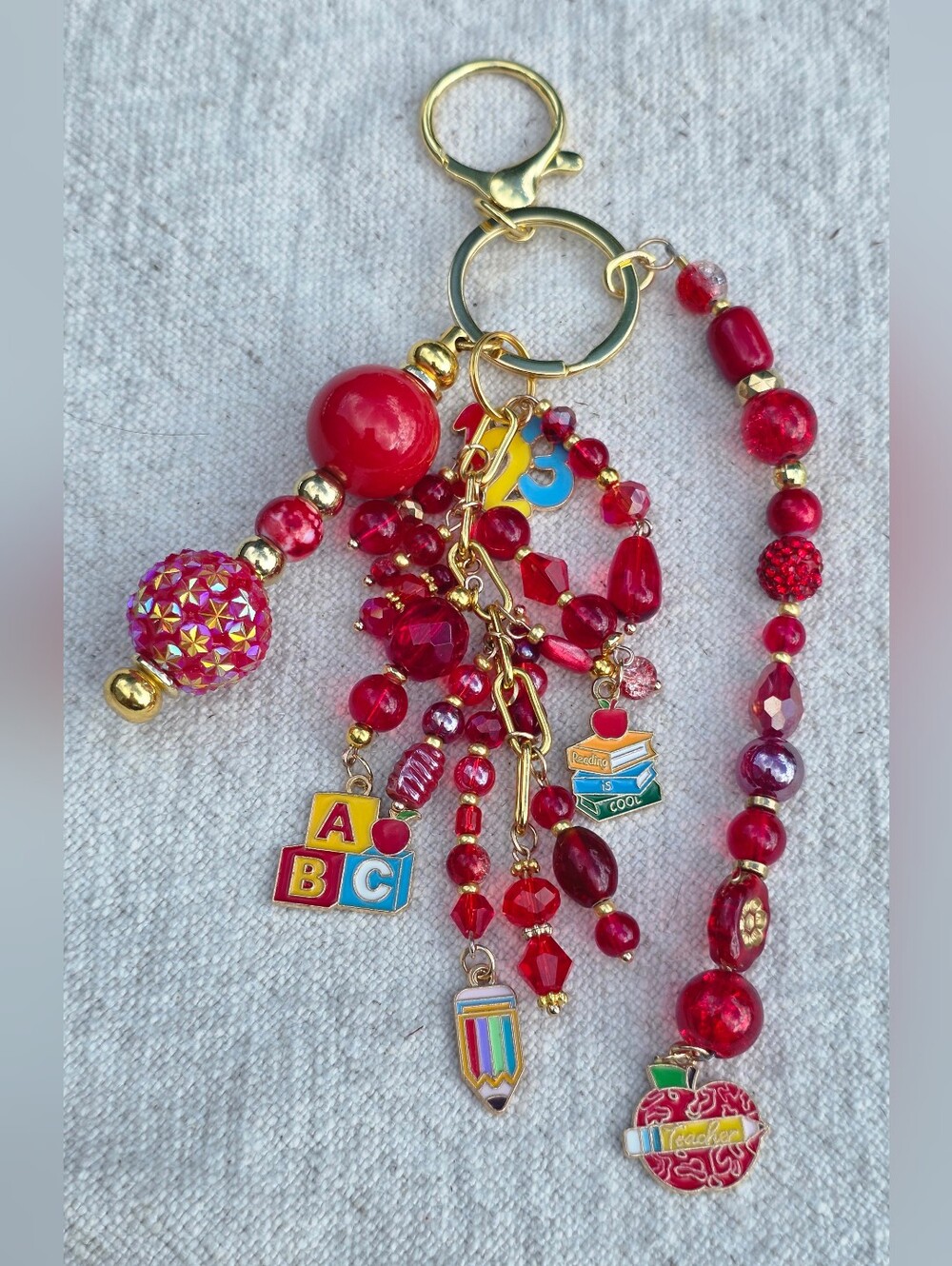 Beaded Red And Gold Colored Teacher Bag Charm With Multiple Charms